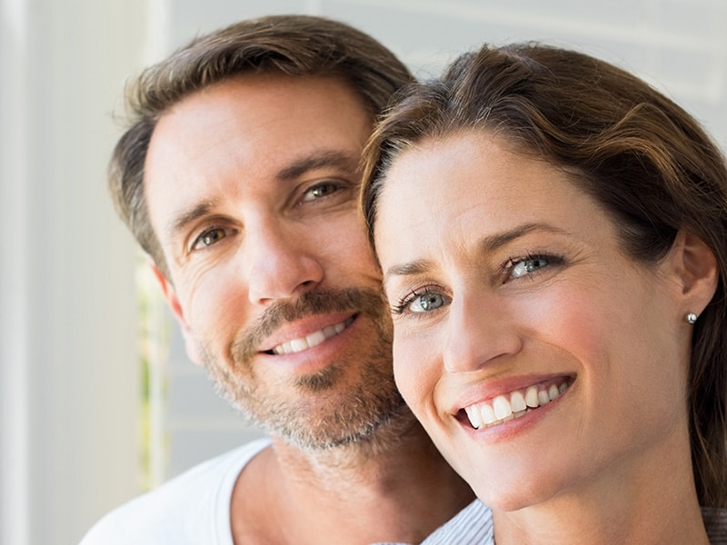 a close up of a man smiling for the camera